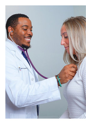 a doctor listens to a patient's heart